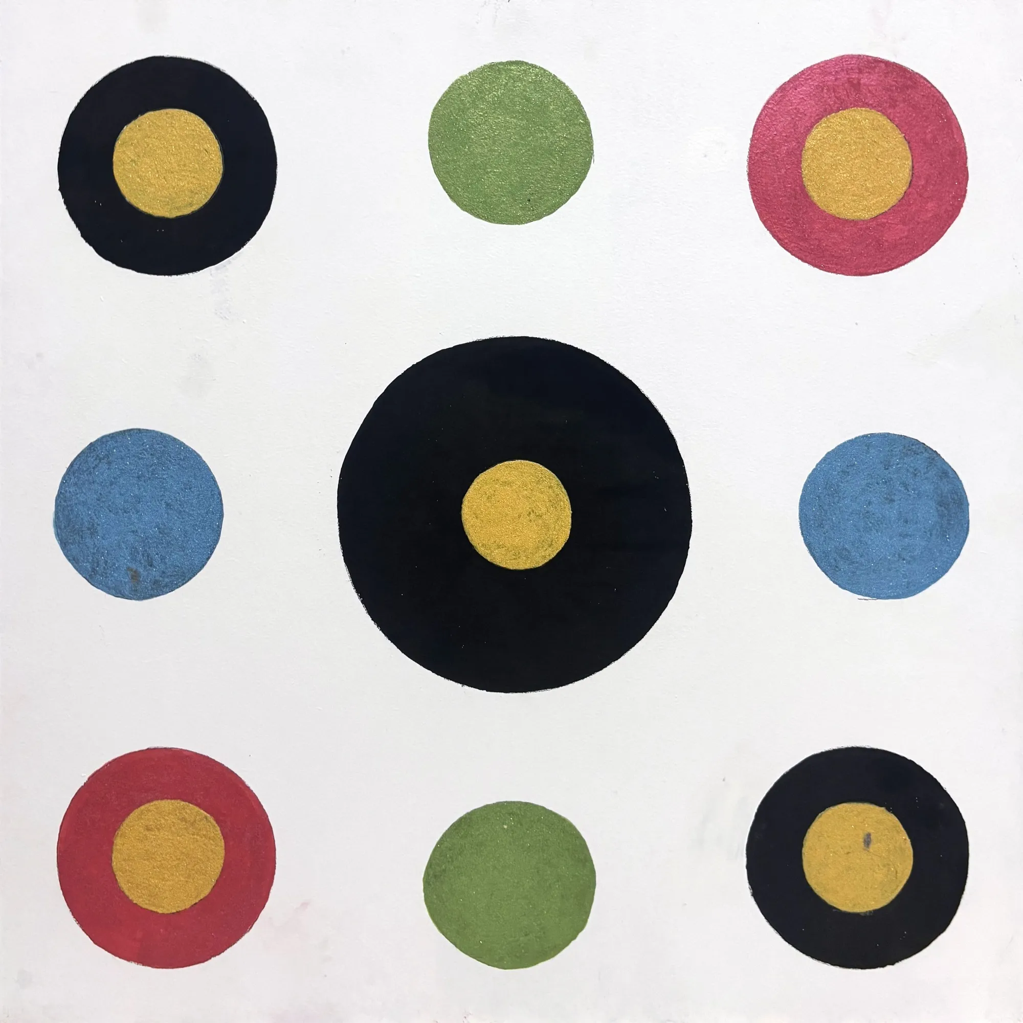 Square geometric abstract painting: a large black circle with a gold centre surrounded by eight smaller black, red, green and blue circles on a white ground
